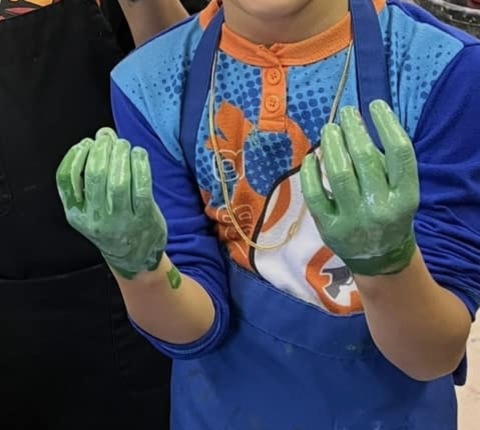 kid with paint on hands